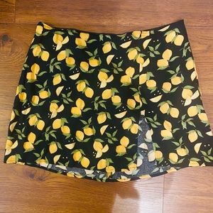 Reformation lemon mini skirt with slit in front.